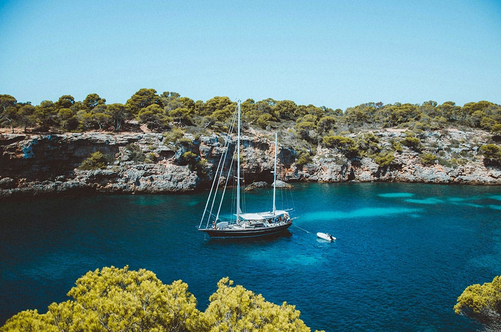 mallorca coastline with a luxury tall ship at anchor