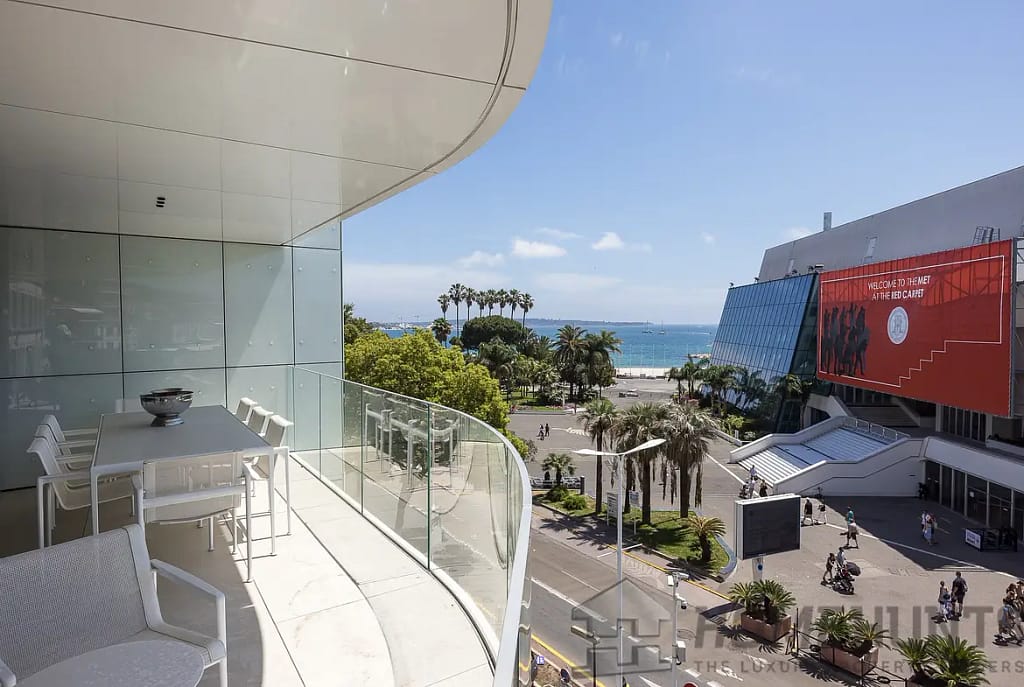 Image of a Croisette apartment terrace overlooking the Palais des Festivals with panoramic views of the sea and Cannes skyline.