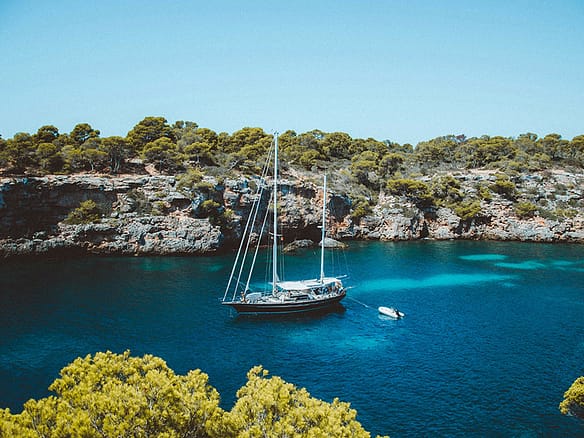 mallorca coastline with a luxury tall ship at anchor