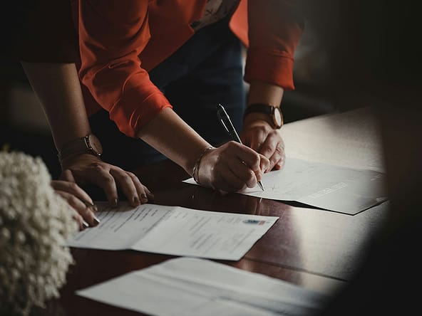 Photo of legal documents being signed
