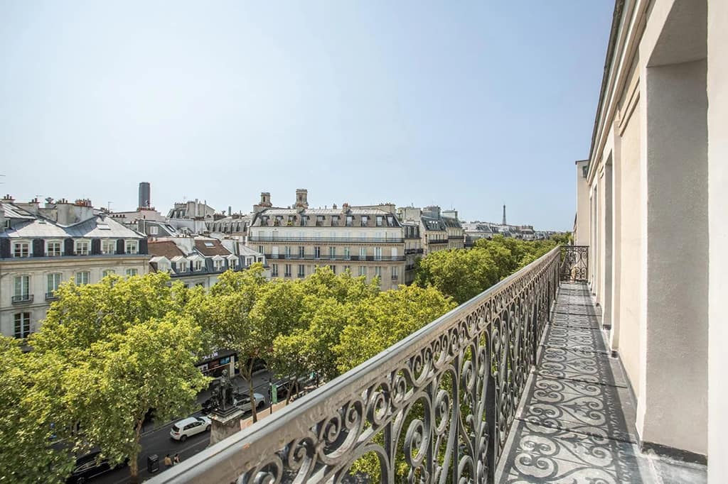 Best (and Most Expensive) Neighborhoods to Buy Luxury Property in Paris 4 Photo taken from an apartment balcony of the Paris skyline in the 6th arrondissement.