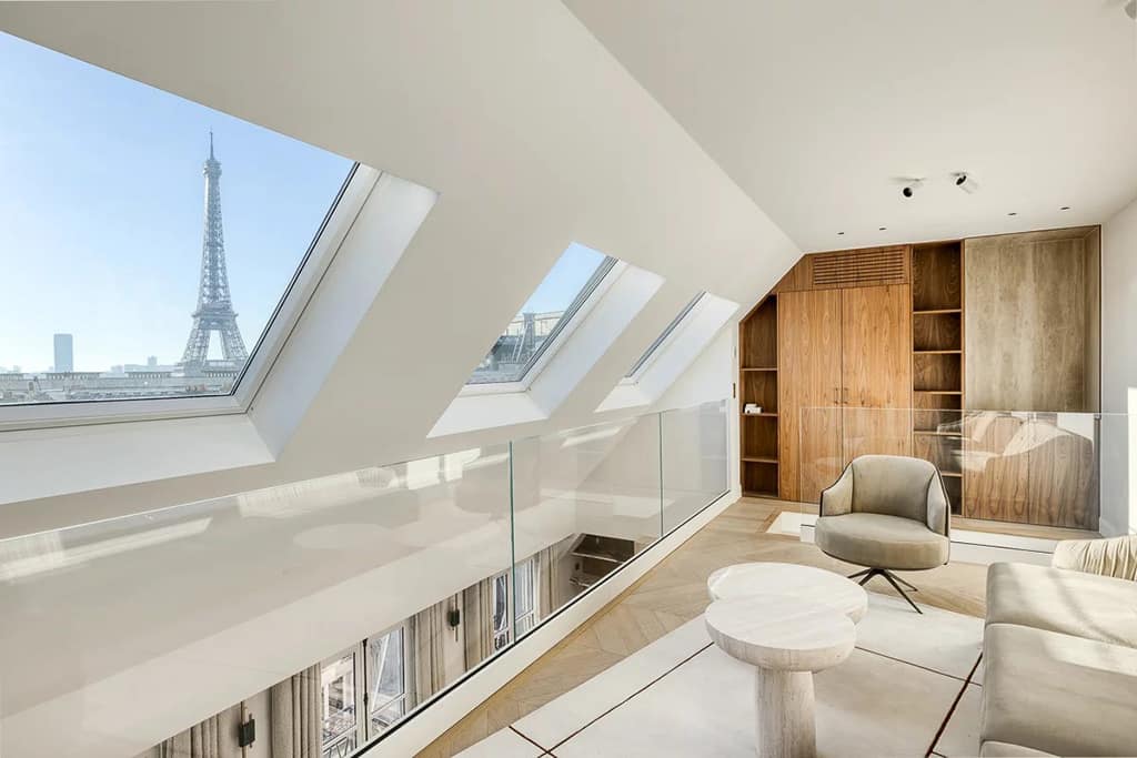 Best (and Most Expensive) Neighborhoods to Buy Luxury Property in Paris 6 Photo of the interior of a modern, luxury apartment in the 16th arrondissement of paris, france with the eiffel tower in the distance.